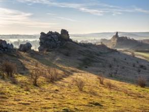 Rock formations in the Teufelsmauer nature reserve in morning light and morning fog, near