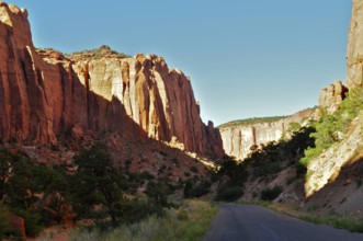 Tall rocks frame a road leading through a dramatic canyon landscape, Grand Staircase Escalante