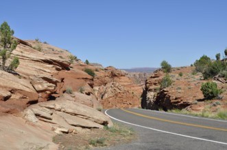 Paved road through red rock landscape under clear blue sky, Grand Staircase Escalante National