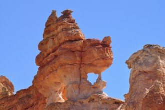 Close-up of sculptural, natural red rock formation under blue sky, Bryce Canyon National Park,
