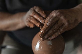 Potter at work making traditional local clay pottery in the Turkish town of Avanos on the river