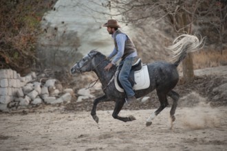 Cappadocia, Turkey. November 8th 2017 Irfan Ozdogan enjoys a gallop on his ranch in the Gorkundere