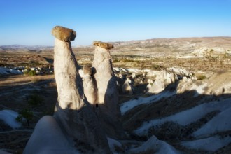 Soft morning light on the fairy chimney rock formations known as the Three Graces, part of the