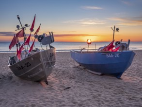 Fishing boats with red flags on fishing beach on the Baltic Sea at sunrise, Baabe, Mönchgut