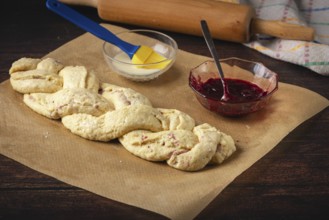 Raw yeast braid next to jam and a bowl of milk