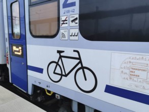Side view of a train with bicycle symbol and blue paint, Polish bicycle compartment, cycling in
