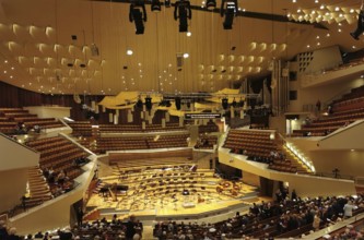 Philharmonie Berlin, modern concert hall with illuminated stage and empty rows of seats, Berlin