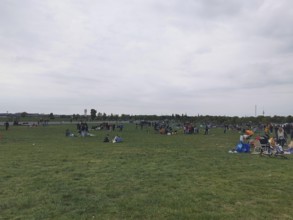 Extensive Tempelhofer Feld with people enjoying free time on a large meadow, Berlin