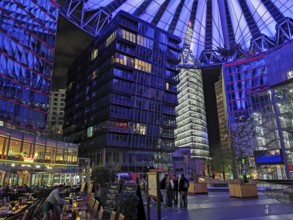 Center am Potsdamer Platz in Berlin at night with blue lighting and lively atmosphere, Berlin