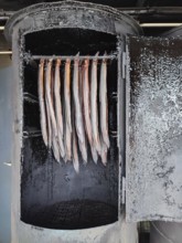 Smoker with hanging fish in a traditional cooking environment, Berlin