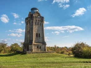 The Bismarck Tower at Großer Fallstein in autumn under a blue sky with fair weather clouds,