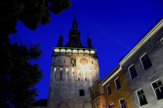 Romania, hour tower at the blue hour in the historic old town of Sighisoara, German Sighisoara,