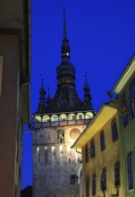 Romania, hour tower at the blue hour in the historic old town of Sighisoara, German Sighisoara,