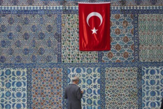 Istanbul, Turkey. 12th October 2021 A man prays in front of beautiful Iznik tiles outside the tomb