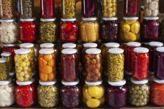 Brightly colored jars of Turkish Tursu, pickled vegetables for sale in an Istanbul Bazar, Turkey