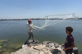 Rosetta, Egypt. June 27th 2024 A local Egyptian fishermen castes his weighted net into the River