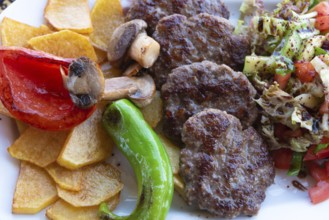 Alanya, Turkey. April 7th 2021 Typical Turkish meal of Kofte with green pepper, mushroom, salad and