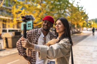 Diverse couple recording engaging video content on a smartphone with a gimbal stabilizer, producing