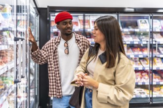 Diverse couple, a black man and a caucasian woman, making decisions about products from a