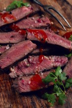 Fried steak, beef steak, rib eye steak, sliced steak, on a chopping board, top view, no people
