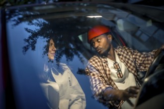 Interracial couple sharing a thoughtful conversation in a car at night, capturing authentic