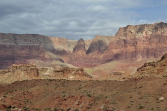 Dramatic rock formations in a vast desert landscape under a cloudy sky, Grand Canyon National Park,