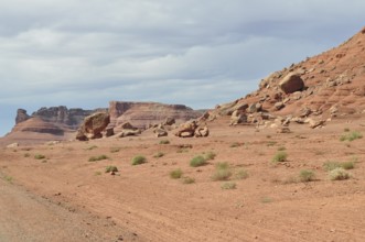 Barren desert landscape with red rock formations and sparse vegetation, Grand Canyon National Park,