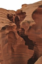 Massive sandstone structures with dramatic fissures, entrance to Antelope Canyon, Navajo Nation