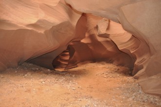 Soil of sand and rocks in an open natural cave with soft curves, Antelope Canyon, Navajo Nation
