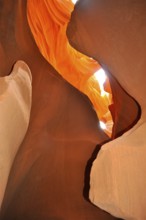 Spectacular rays of light penetrate organic orange sandstone formations, Antelope Canyon, Navajo