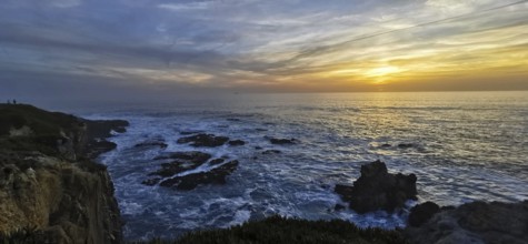 The golden sun sets over the vast sea, illuminated by bright clouds, hiking on the Fisherman's