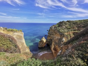 Picturesque coastal landscape with high cliffs and turquoise blue sea, Lagos, Algarve, Portugal