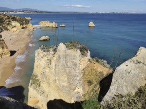 Breathtaking coastal view with sandy beaches and imposing rock faces, Lagos, Algarve, Portugal
