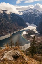View from above of the partly icy Königssee and Sankt Bartholomä, in the back Funtenseetauern,