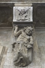 Sculpture of a man, Atlant under a 19th century balcony, Lviv, Ukraine