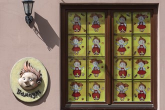 Window of a toy store covered with children's comics, Lviv Ukraine