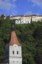 Town of Rasnov, German Rosenau. In the foreground is the distinctive clock tower of the Protestant