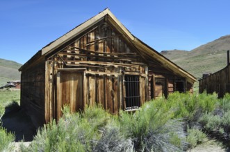 An old abandoned wooden house, blacksmith's workshop, Schmitte, in a landscape surrounded by
