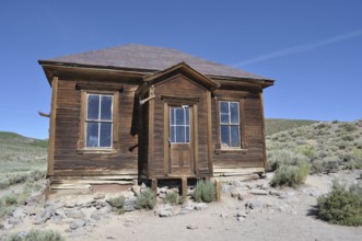 Ruined wooden house in a ghost town surrounded by arid countryside, Bodie Ghost Town, California,