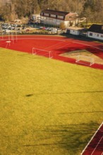 Close-up of a sports field with running track and shade on the grass, Wimberg, Calw, Germany