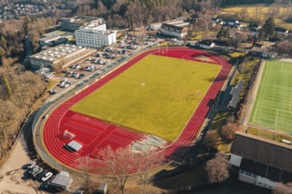 Sports ground with red track and adjacent buildings and parking spaces from the air, Wimberg, Calw,