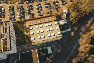 Aerial view of a flat roof and adjacent parking lot with lots of cars, Wimberg, Calw, Germany
