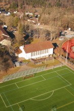 Aerial view of a soccer field with adjacent grandstand and surrounding trees, Wimberg, Calw,