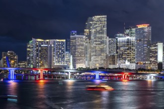 Miami skyline with high-rise real estate in downtown by the ocean at night in Miami, USA