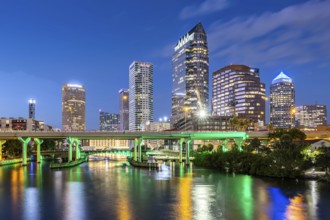 Tampa skyline with skyscrapers and bridge over Hillsborough River at night in downtown Tampa, USA