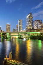 Tampa skyline with skyscrapers and bridge over Hillsborough River at night in downtown Tampa, USA