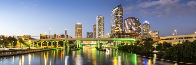 Tampa skyline with skyscrapers and bridge over Hillsborough River at night panorama in downtown