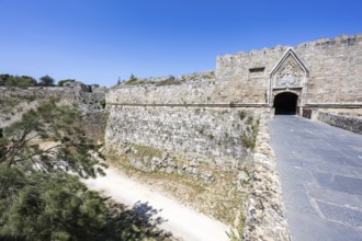 Red gate from the Middle Ages in the city wall of the historic old town on the island of Rhodes,