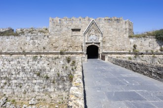 Red gate from the Middle Ages in the city wall of the historic old town on the island of Rhodes,