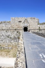 Red gate from the Middle Ages in the city wall of the historic old town on the island of Rhodes,